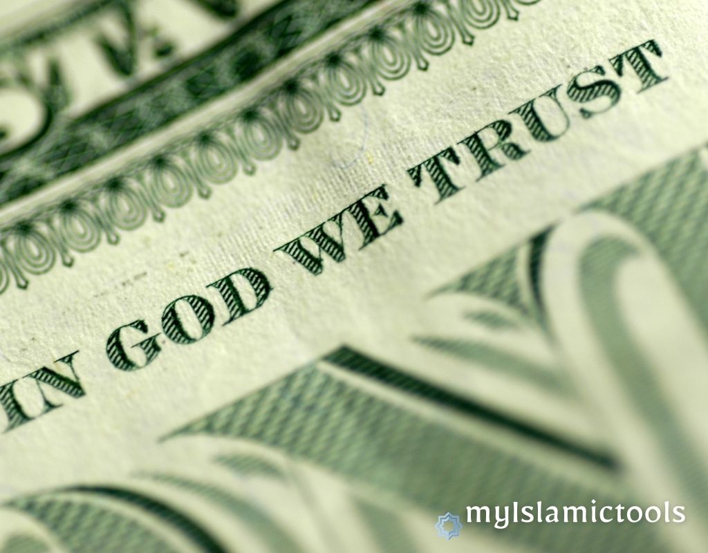 A close-up of a dollar bill showing the words 'In God We Trust,' illustrating a key piece of Islamic advice for financial problems.